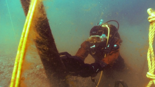 Diver inspects the beam.